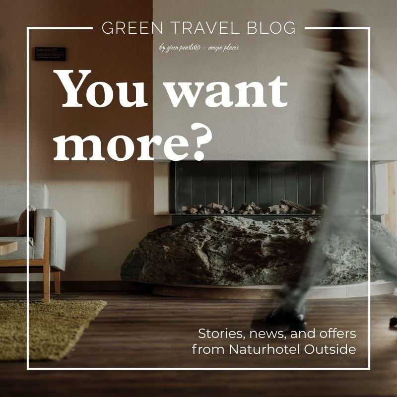 The cozy lobby of the Naturhotel Outside with a stone fireplace, modern furniture, and wooden floors. In large letters it says: “Want more?” A person walks by and causes a stir.