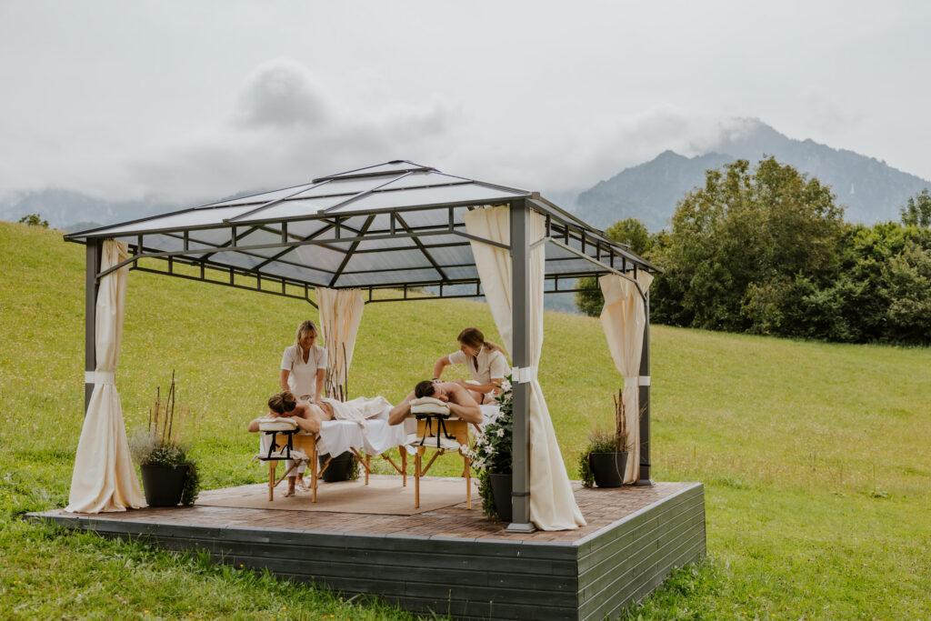 Couple treatment on the Klosterhof Alpine Hideaway & Spa meadow
