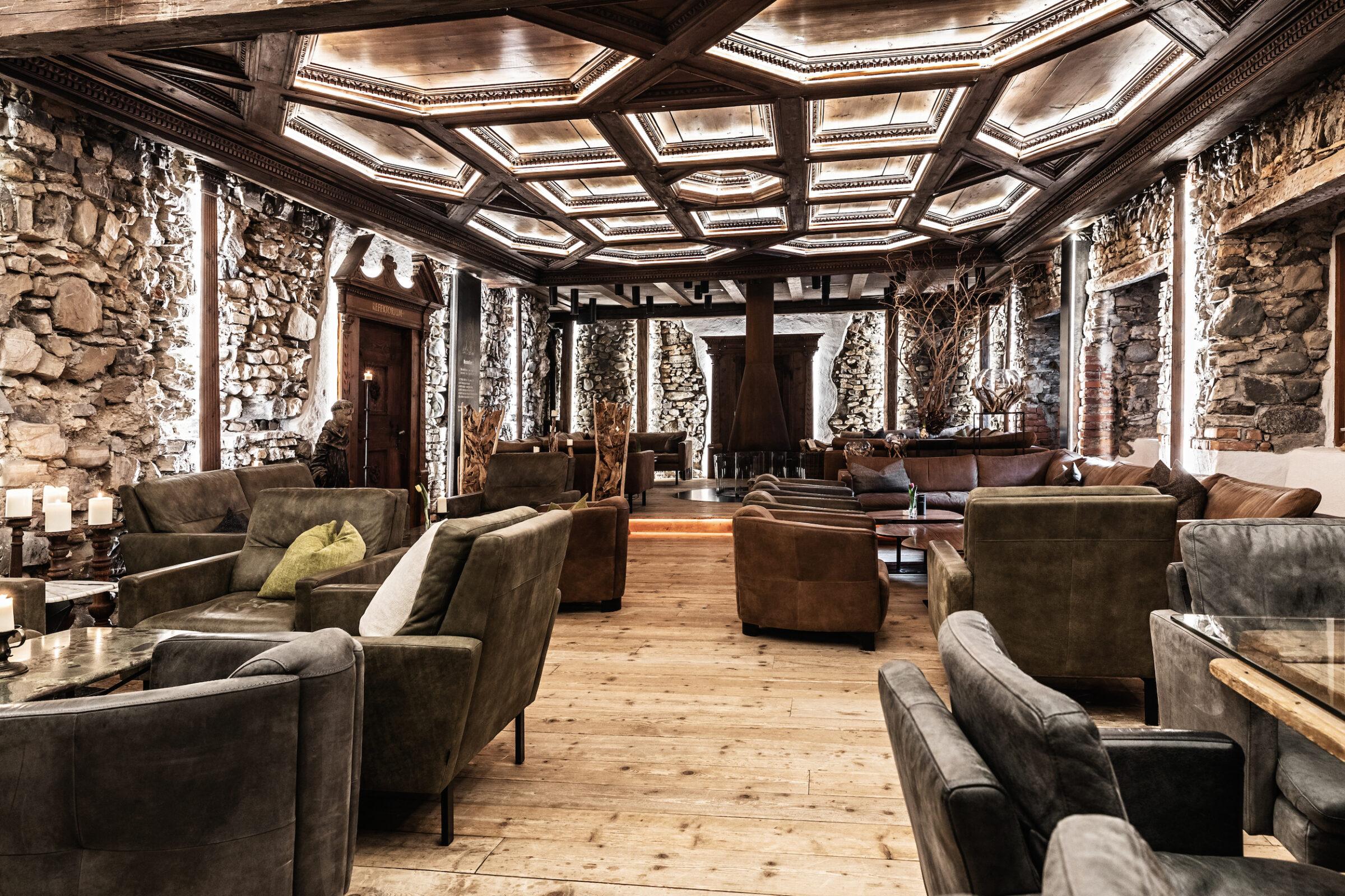 Lobby and recreation area at the Hotel Klosterbräu. There are comfortable-looking armchairs and small tables everywhere.