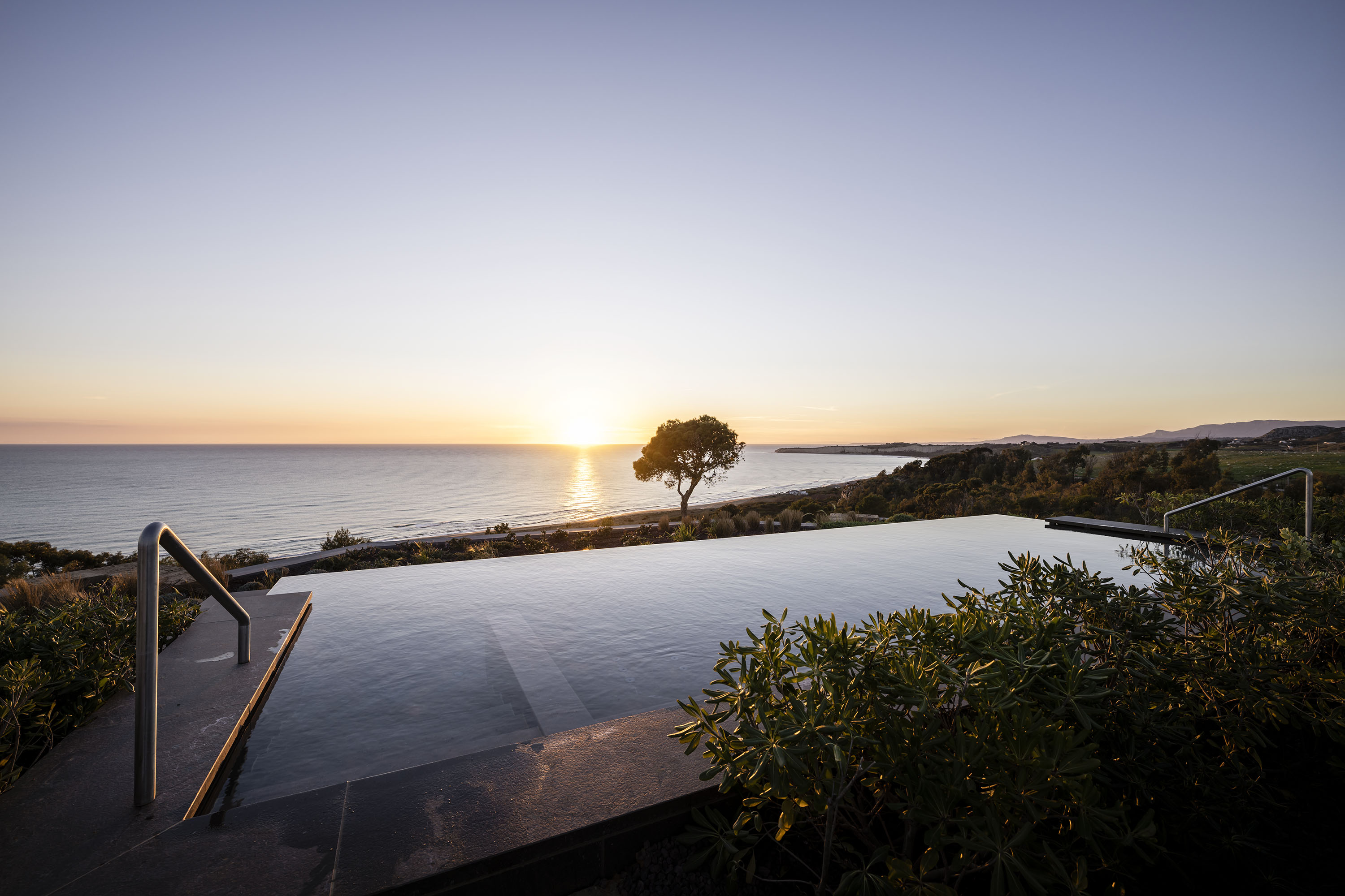 Sunset view on the Mediterranean sea with pool. Sustainable Travel in Italy