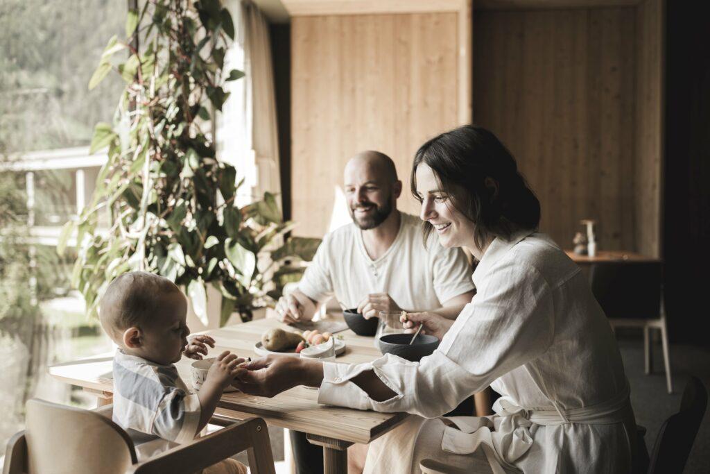 Young family enjoying a regional organic breakfast at the sustainable OLM Nature Escape aparthotel