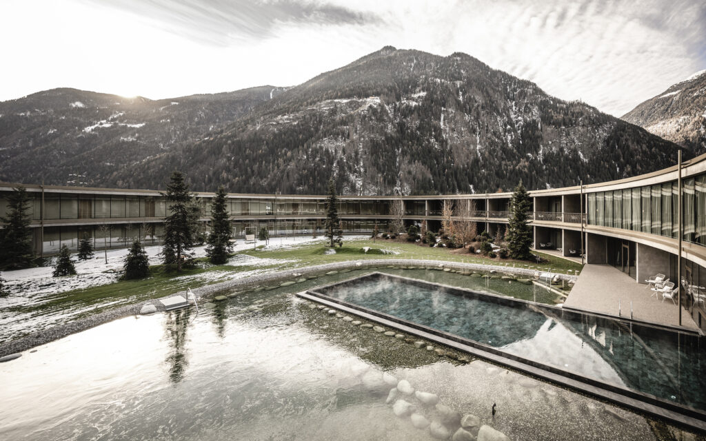 Sustainable and energy self-sufficient aparthotel in South Tyrol: outdoor pool and natural pond at OLM Nature Escape