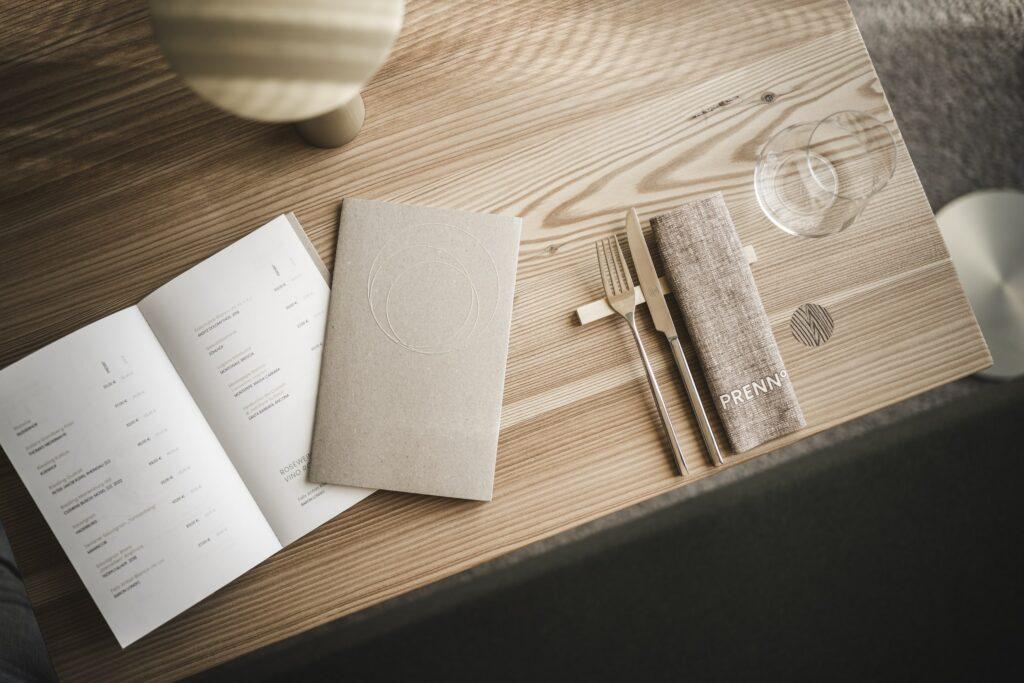 Restaurant furnishings with menu, napkin, and cutlery from the PRENN° Restaurant at the sustainable OLM Nature Escape