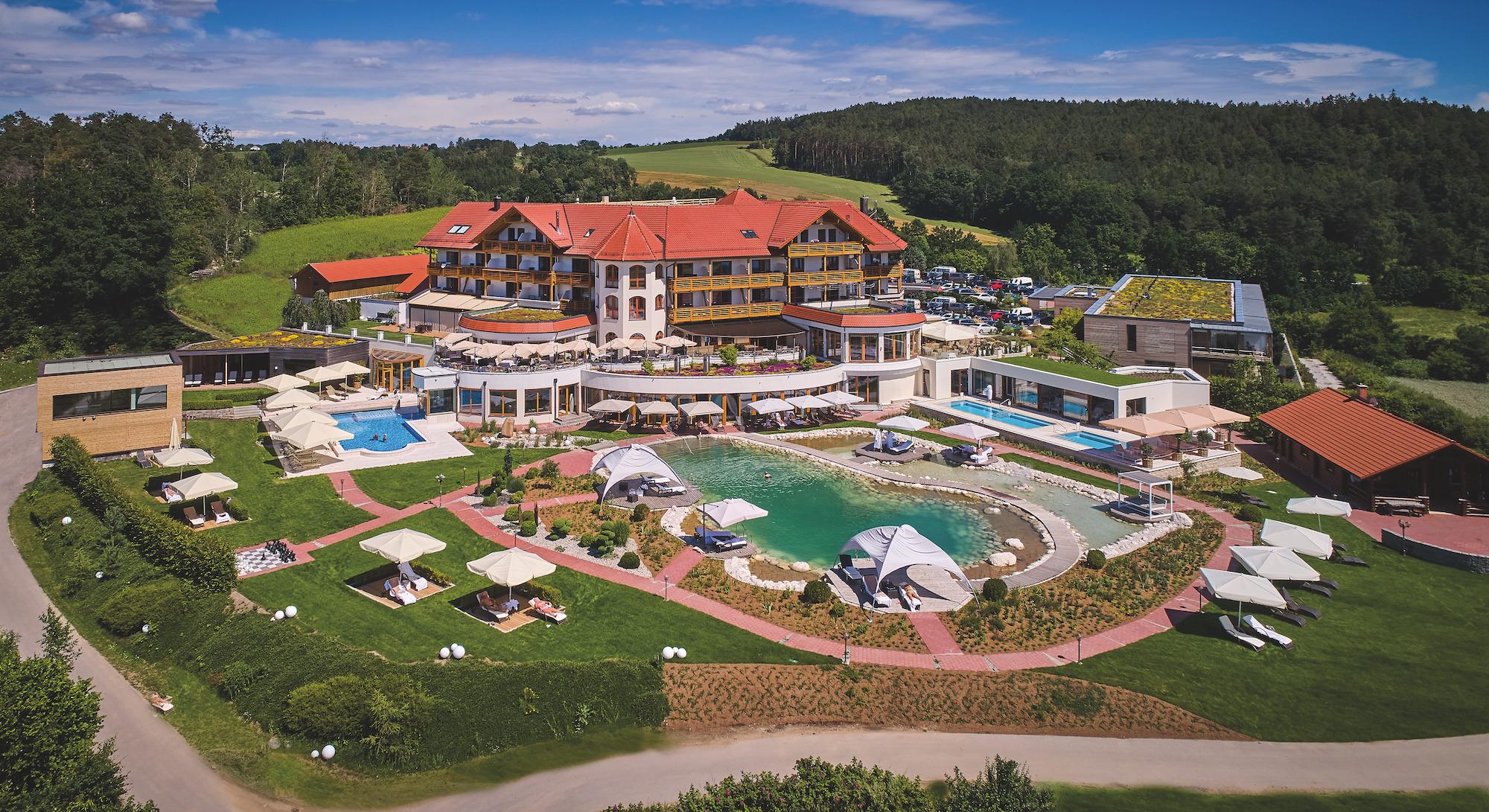 View of the sustainable Hotel Birkenhof with outdoor facilities and pool