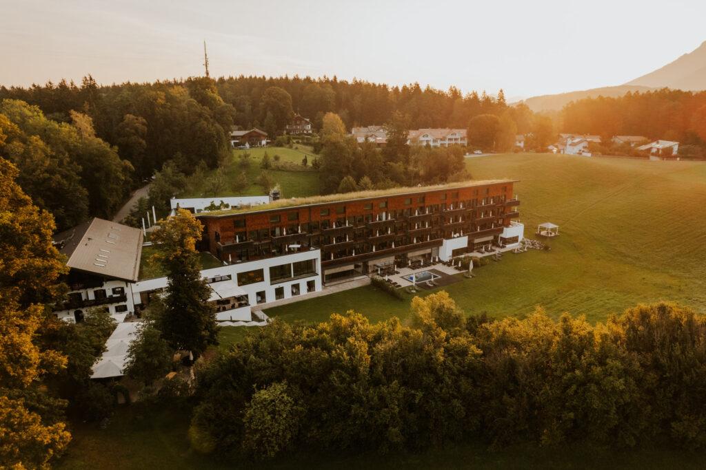 View of the sustainable wellness hotel Klosterhof Alpine Hideaway & Spa at sunset